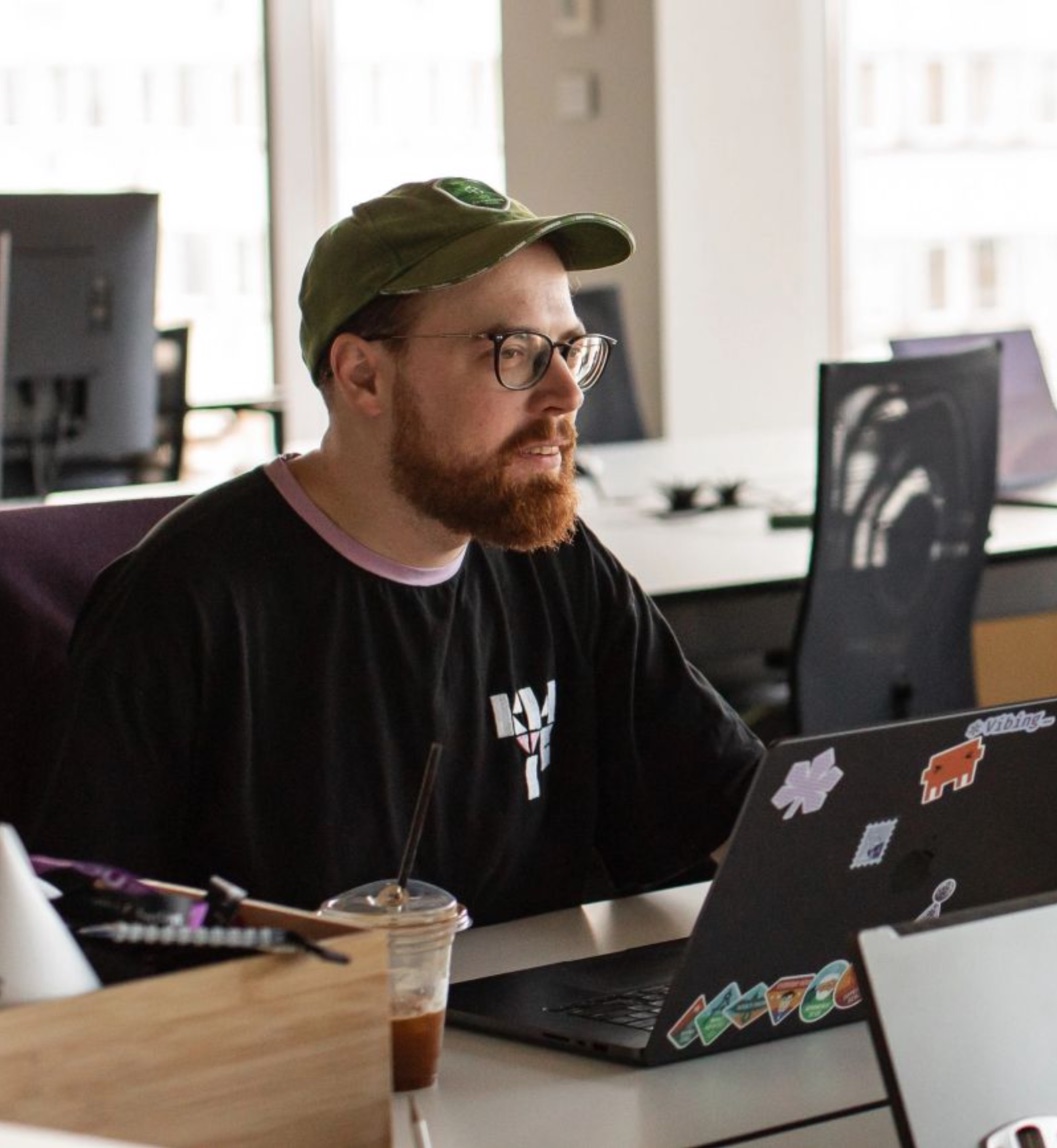 Yaroslav at his laptop in an office work area.